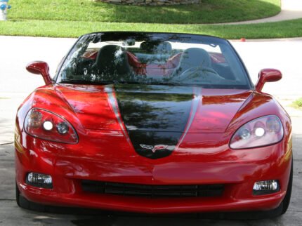 Red C6 Corvette with metallic black and gunmetal ME stripes