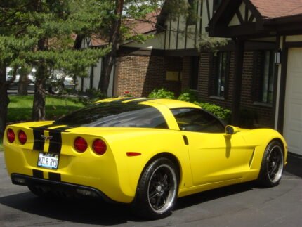 Yellow C6 Corvette with black racing stripe