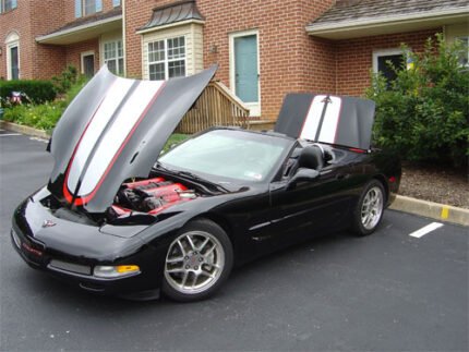 Black C5 Corvette with silver and red CE commemorative stripes