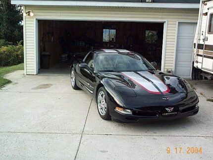 Black C5 Corvette with silver and red CE commemorative stripes