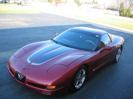 Magnetic red C5 Corvette with gunmetal and silver CE commemorative stripes