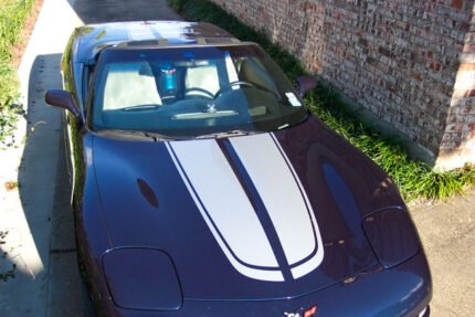 Navy blue C5 Corvette with silver CE commemorative stripes