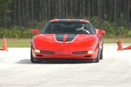 Torch red C5 Corvette with black and silver CE commemorative stripes