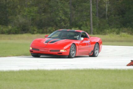 Torch red C5 Corvette with black and silver CE commemorative stripes