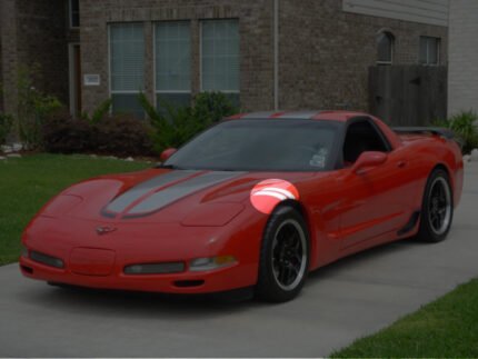 Torch red C5 Corvette with silver and black CE commemorative stripes