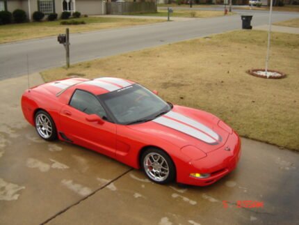 Torch red C5 Corvette with silver and black CE commemorative stripes