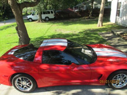 Torch red C5 Corvette with white CE commemorative stripes