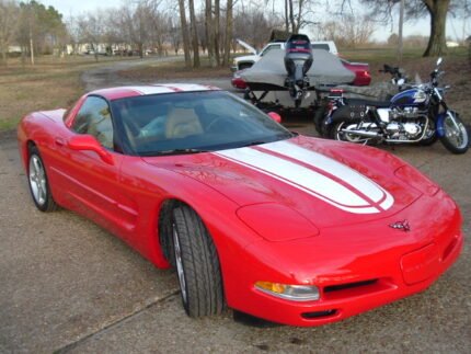 Torch red C5 Corvette with white CE commemorative stripes