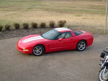 Torch red C5 Corvette with white CE commemorative stripes