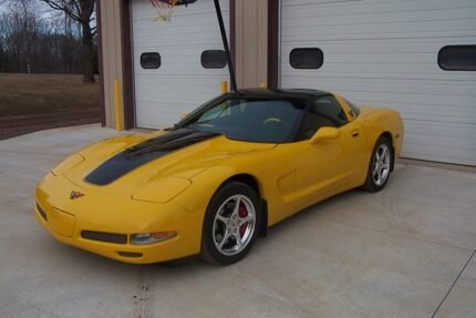 Yellow C5 Corvette with black classic stripes