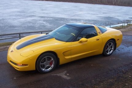 Yellow C5 Corvette with black classic stripes