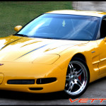 Yellow C5 Corvette with black hood spear stripe