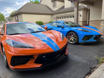 Amplified orange and rapid blue C8 Corvette with full length dual racing stripes