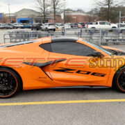 Amplified orange C8 Corvette Z06 with Z06 door script in 3M 2080 gloss carbon flash