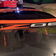 Amplified orange C8 Corvette Z06 with Z06 windshield script in amplified orange and silver