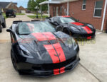 Black C7 Z06 Corvette with GM full length dual racing ME stripes in red