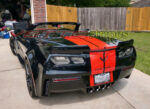 Black C7 Z06 Corvette with GM full length dual racing ME stripes in red