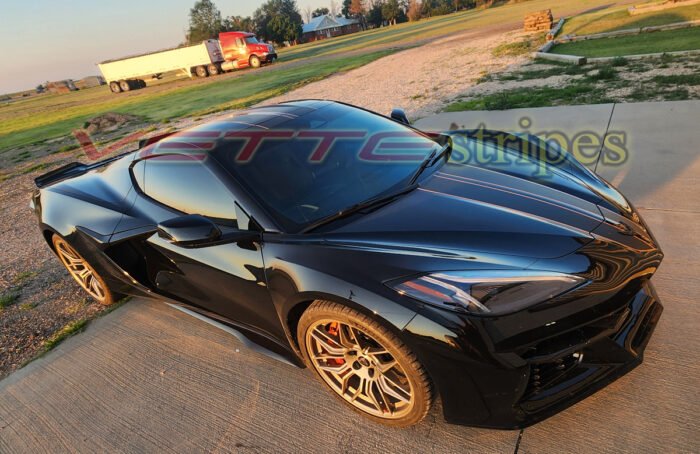 Black C8 Corvette Z06 with matte carbon flash and amplified orange full length dual racing stripes