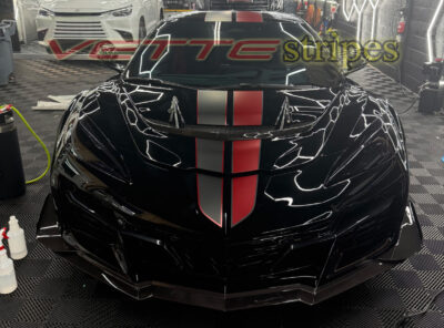 Black C8 Corvette ZR1 with asymmetrical full length dual racing stripes in satin carbon flash and satin red