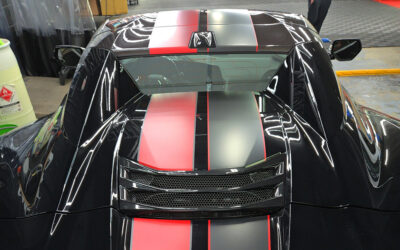 Black C8 Corvette ZR1 with asymmetrical full length dual racing stripes in satin carbon flash and satin red