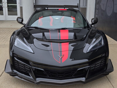 Black C8 Corvette ZR1 with asymmetrical full length dual racing stripes in satin carbon flash and satin red