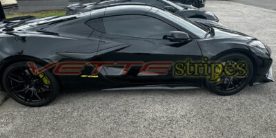 Black Z06 Corvette with accelerate yellow Z06 emblem overlay