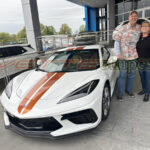 White C8 Corvette with 2024 full length dual racing stripes in Texas Longhorn orange