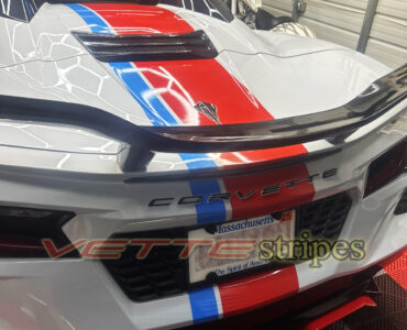 White C8 corvette Stingray vert with cardinal red and rapid blue racing stripes